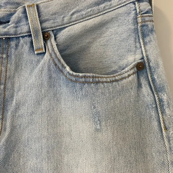 Levi’s 501 Distressed Light Wash Denim Jeans straight leg raw hem
